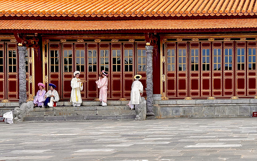 Vietnamese women dressed in traditional ao dai costume in the Hue Citadel
