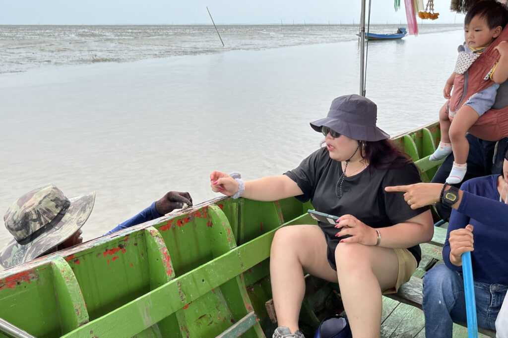 Asia My Way team member speaking with local fisherman in Samut Songkhram mangrove, Thailand