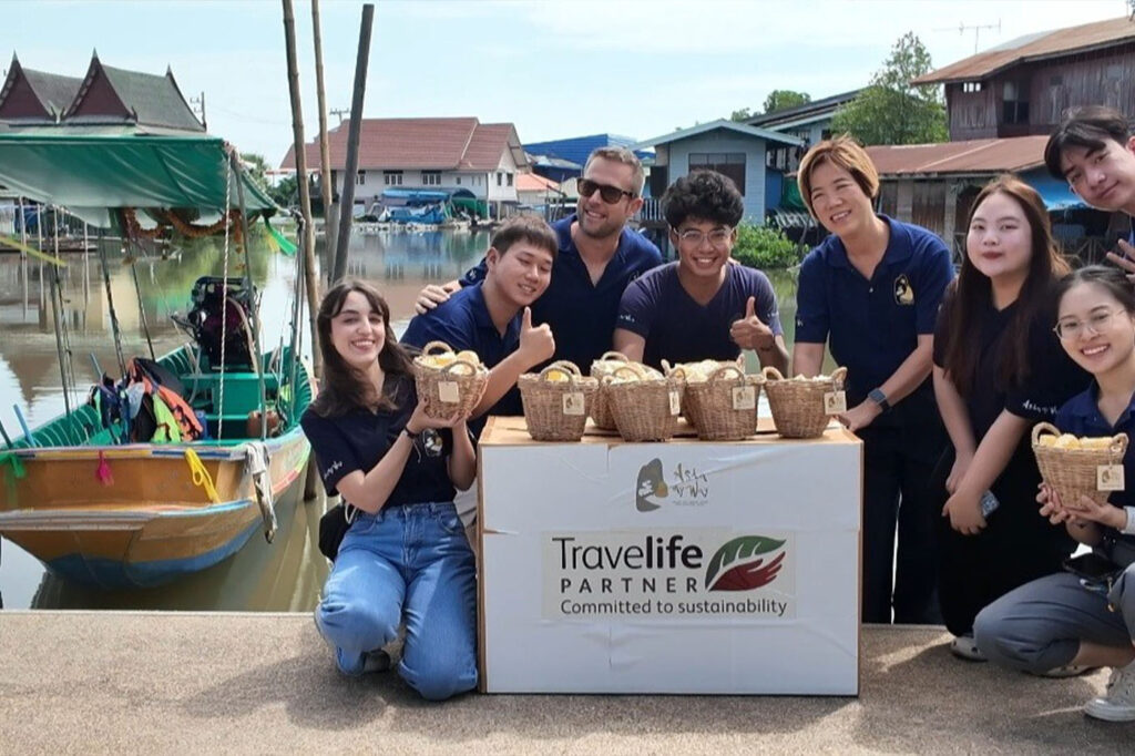 Asia My Way team offering reusable wicker baskets to local boat operator in Thailand